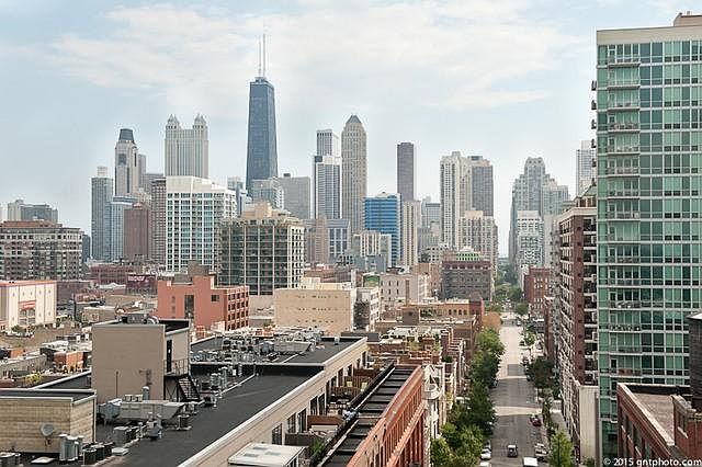 Amazing city views looking east towards the lake from the 40 foot long balcony, primary bedroom, living room and kitchen.