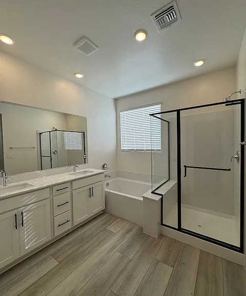 Primary Bath w/natural light, dual sinks, large soaking tub and separate water closet.