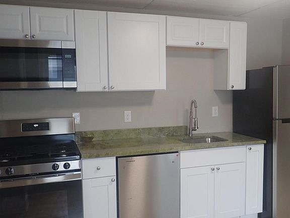 Newly renovated kitchen: stainless steel appliances and granite countertop
