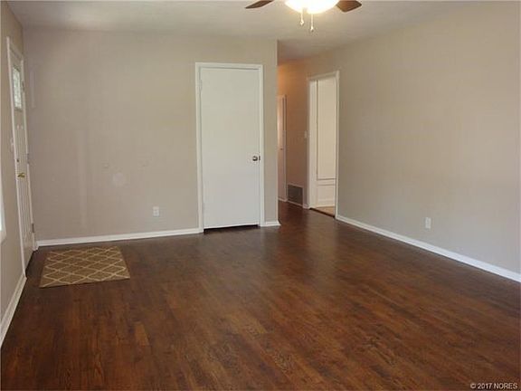 Living room looking towards hall to bedrooms. Kitchen entrance on right.