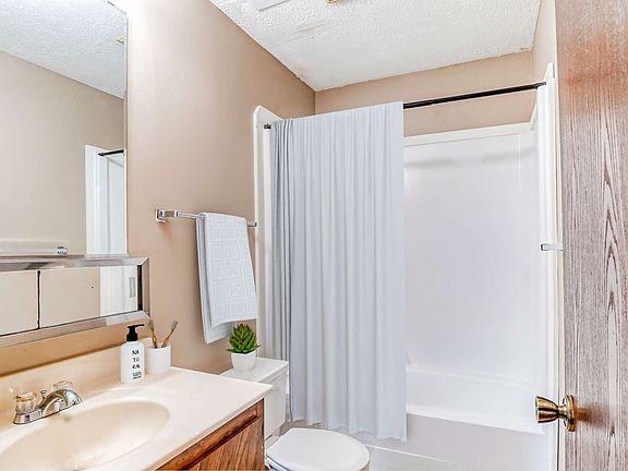 Bathroom shower tub toilet sink included bright walls