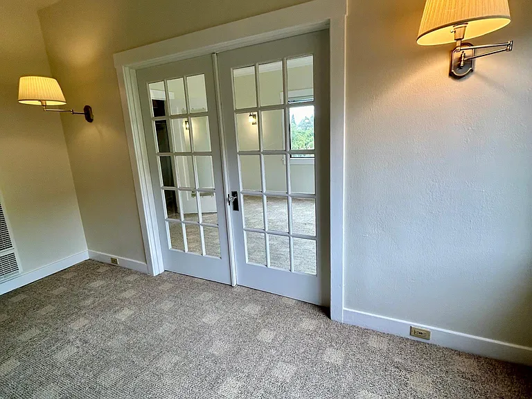French doors separate the living space and the bedroom