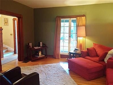 Beautiful tile fireplace and hearth with oak mantel and beveled mirror is the showpiece of the living room.  (Fireplace is non-operational.)