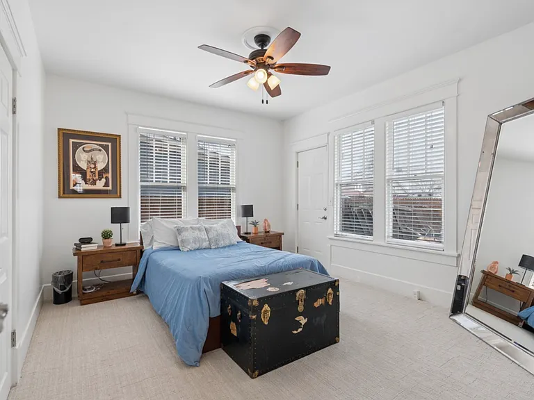 Bright and peaceful, this spacious main-level bedroom offers a private retreat with direct access to the backyard and plenty of room to recharge after a busy day.