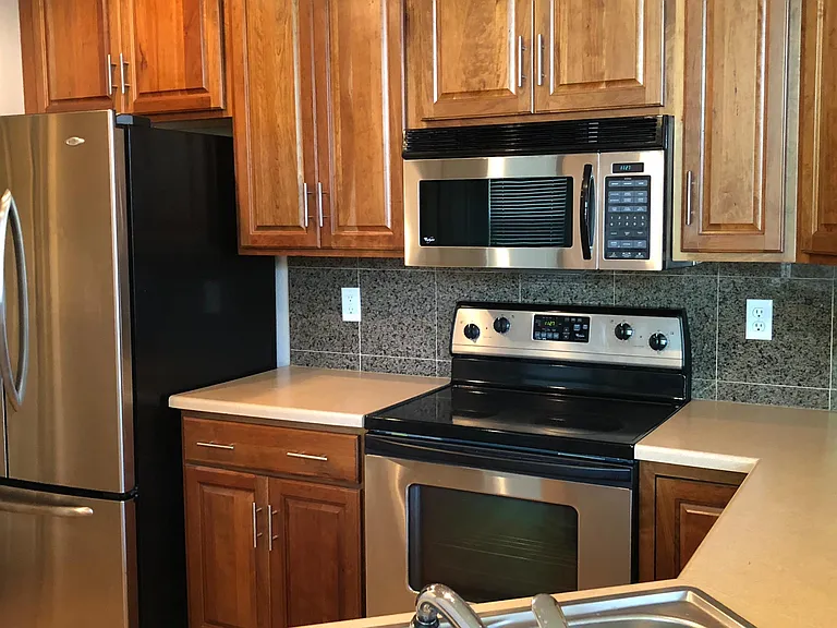 Super Functional Kitchen now has been remodeled with white subway tile and quartz counter tops! (This older photo doesn't show the white subway tile backsplash.)