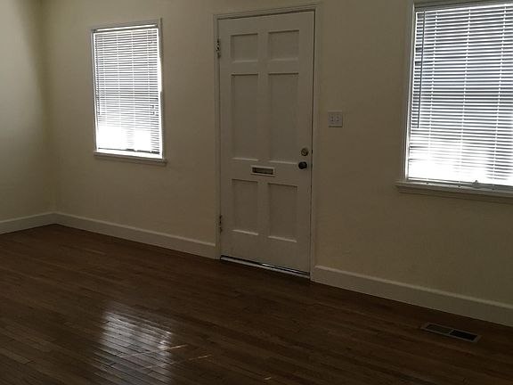 Showing front door, hardwood floors, living room