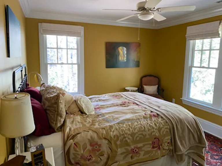 Ensuite gold bedroom with queen bed overlooking water fountain