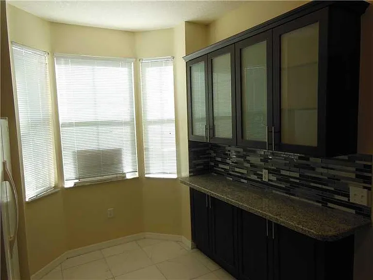 Updated kitchen includes granite counters & updated cabinets.