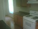 Galley kitchen gas range and pergo floors