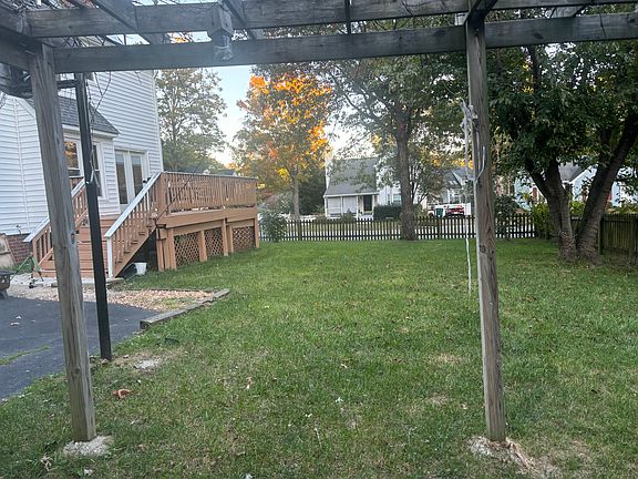 Large back lawn, perfect for a garden, there are grape vines, tomato, cucumber, and pepper plants, and berry trees and fig trees