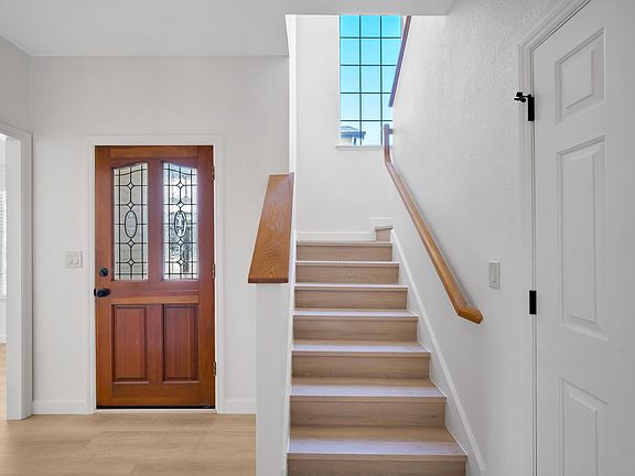 Front Door to Foyer Lower Bathroom and Staircase Leading to upper Bedrooms and bathrooms.