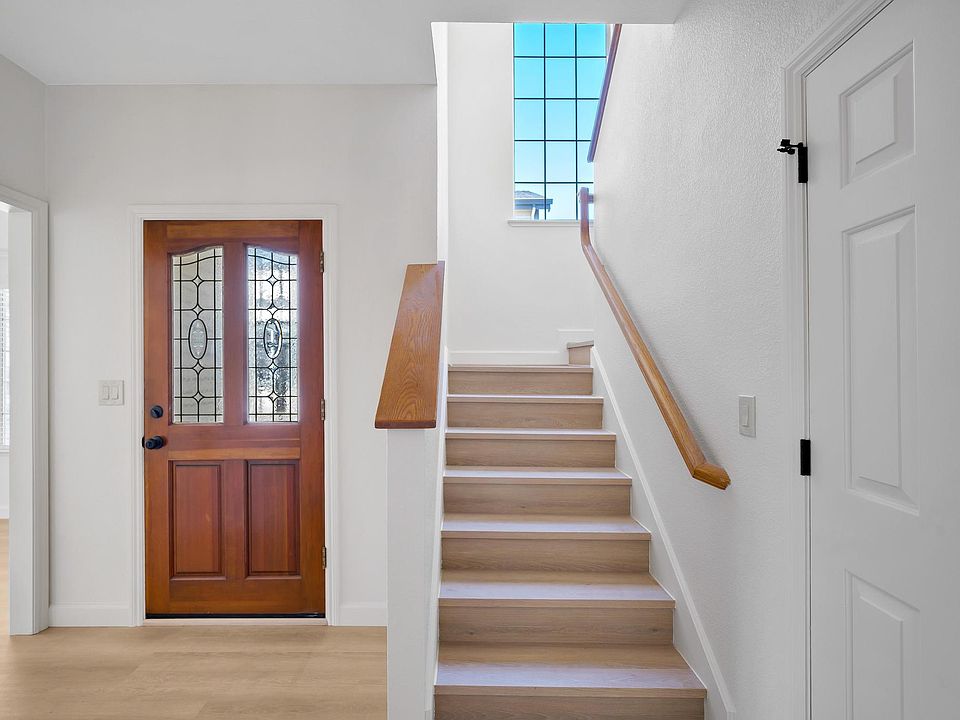Front Door to Foyer Lower Bathroom and Staircase Leading to upper Bedrooms and bathrooms.
