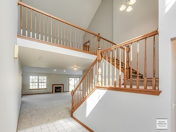 View of the foyer into the DR / FR and Loft area upstairs
