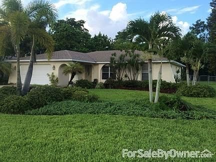 Front of Home : Beautifully landscaped yard with automatic sprinkler system.