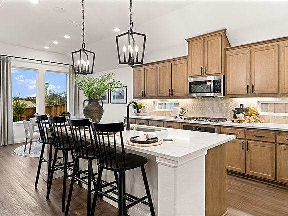 Westlake II one-story floor plan featuring open living spaces, a game room, covered patio, and a pri