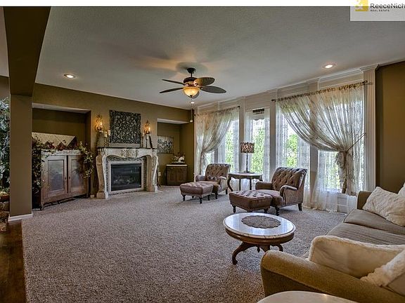 Beautiful fireplace mantle enhanced by high ceilings!