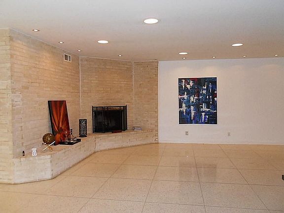 Alternate view of the living room. Terrazzo flooring, recess lighting, plenty of wall space to show off your art work.
