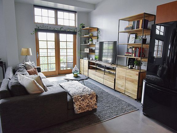 Comfy living area with 55" Roku smart TV and Sonos sound bar.