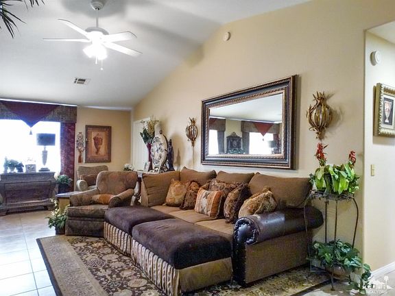 Living Room with Vaulted Ceilings and ceiling fan