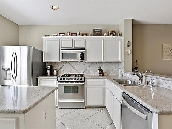 Beautiful kitchen with custom built cabinets, Avonza countertop, island and a pantry for all your storage needs. Open to the dining room and living room.