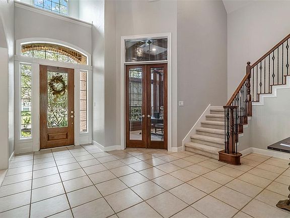 Large entry-way with 2 story ceiling.  Study with glass doors and transom for additional light.
