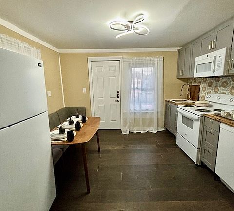 The newly renovated kitchen awaits homecooked meals or delivery from the local pizza shop.