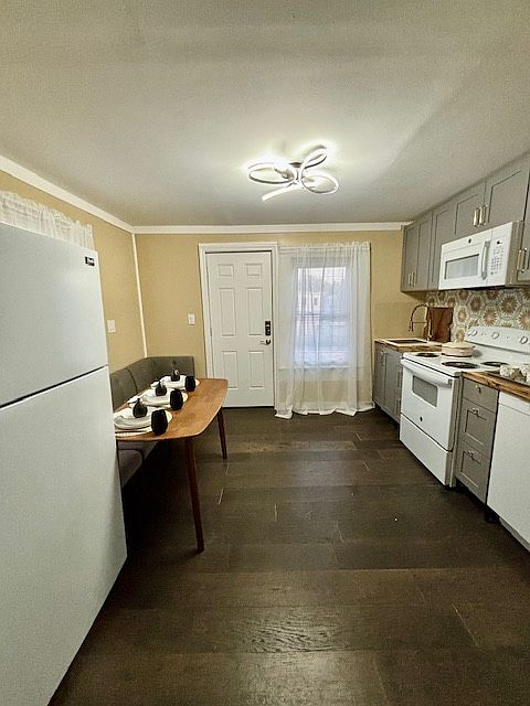 The newly renovated kitchen awaits homecooked meals or delivery from the local pizza shop.