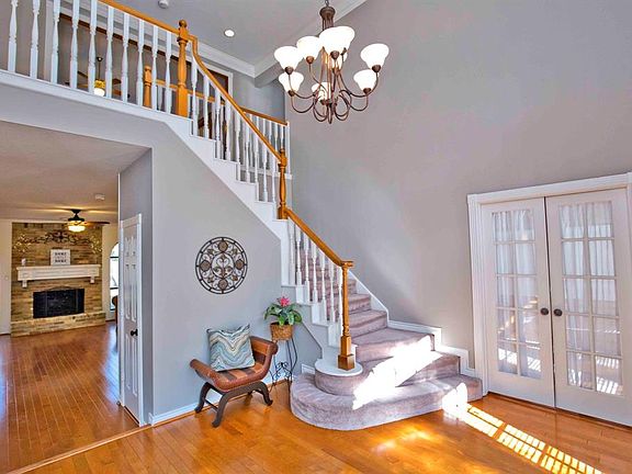 The family room stretches beyond the foyer, the private study lies to the right, and the game room is tucked up the staircase; m