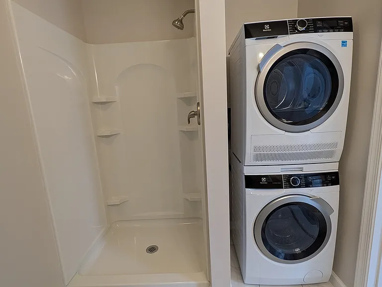 Roomy bathroom with a new shower and brand new washer/dryer