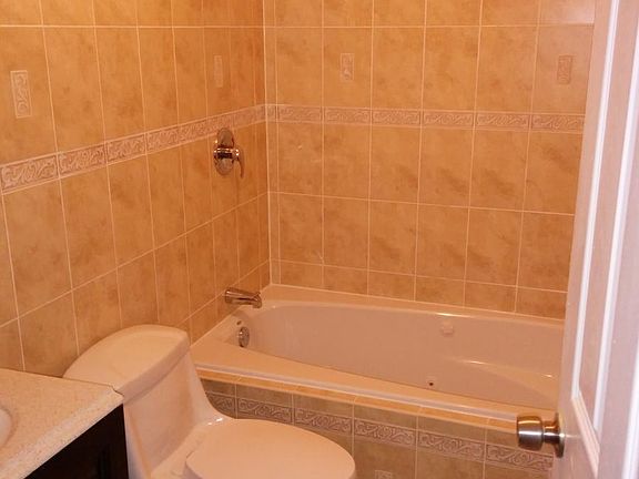 Decorative tan and brown colored ceramic tile with a jacuzzi