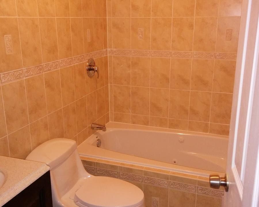Decorative tan and brown colored ceramic tile with a jacuzzi