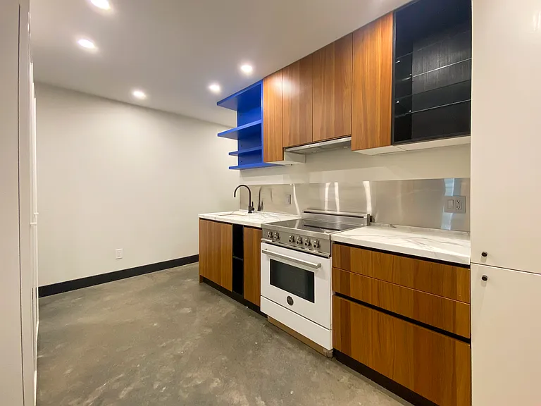 Kitchen with induction range, marble countertops