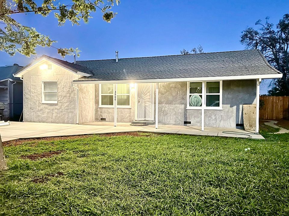 Front of house, patio, and driveway.