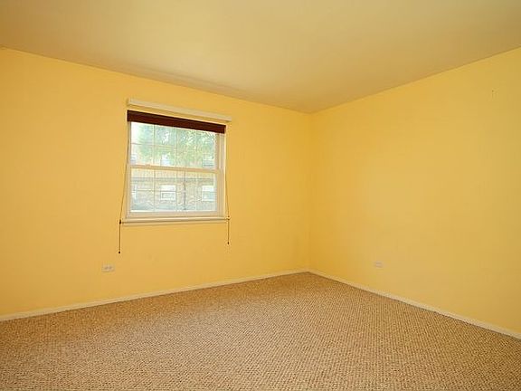 Large Bedroom with neutral decorating and Berber carpeting.