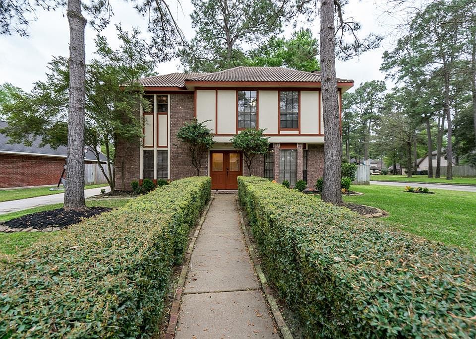 Lovely four bedroom home on oversized corner / cul-de-sac lot in Cypresswood subdivision.