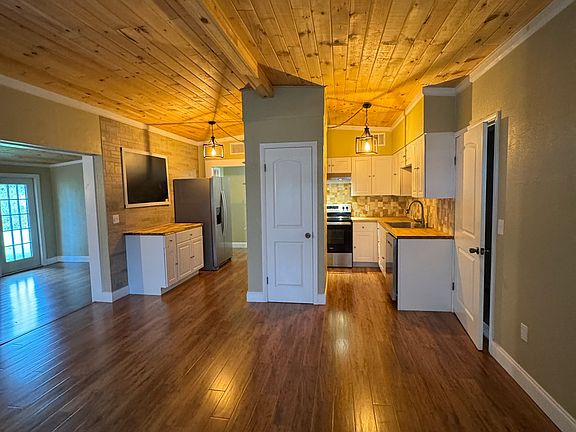 Enter into the living room that looks into the kitchen.