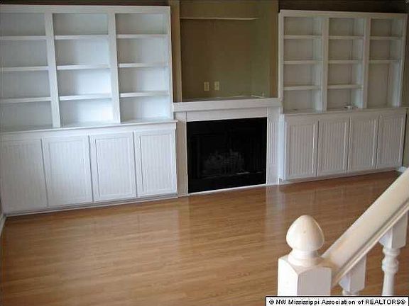Greatroom w/ wood like flooring & Built-in Bookshelves