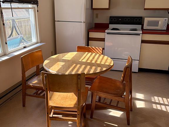 Dining area and kitchen adjoin the living room; the deck is just outside
