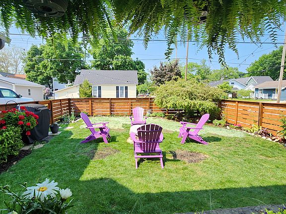 Fenced in yard with fire pit. Alley to the back and two card parking off to the side