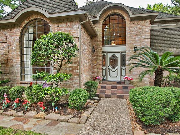 The unique features of this home are evident immediately, with the huge arched widows providing warm, natural light to the entry foyer and formal dining room. The paned windows are beautiful at night, allowing the homes interior lights to complement 