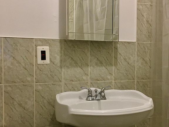 Fully tiled bathroom with new medicine cabinet