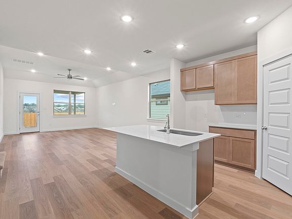 Kitchen in the Pearl home plan by Trophy Signature Homes - REPRESENTATIVE PHOTO