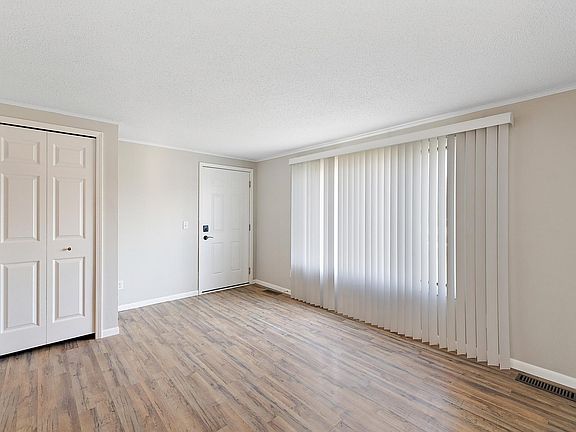 living room looking toward the door. Good sized coat closet and large front window