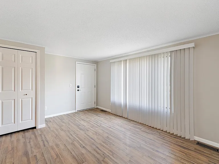 living room looking toward the door. Good sized coat closet and large front window