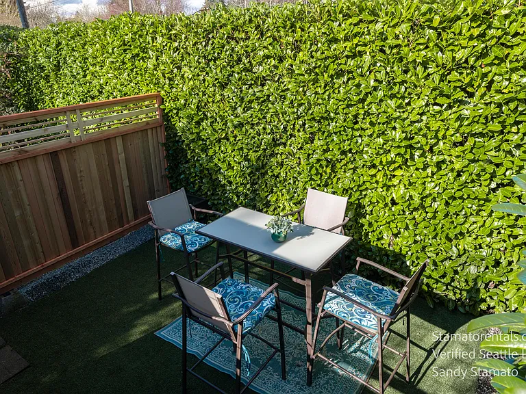 Surrounded by mature greenery, the lower patio provides a secluded setting just steps from the home.
