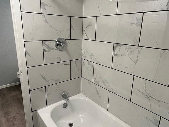 Shared shower with tiled backsplash