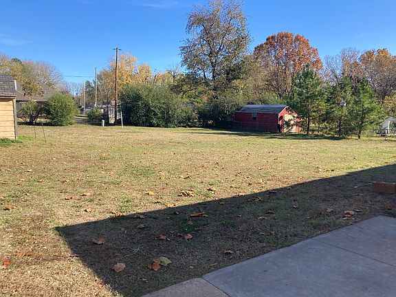 large backyard with detached storage shed