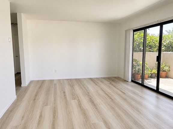 Very spacious Living room with large patio. Note: AI was used to remove some personal picture on walls.