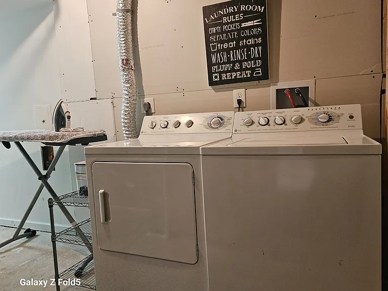 Your own private laundry set up with drying rack and ironing board. An additional 10' X 12' bonus space is accessed through this area of laundry room.