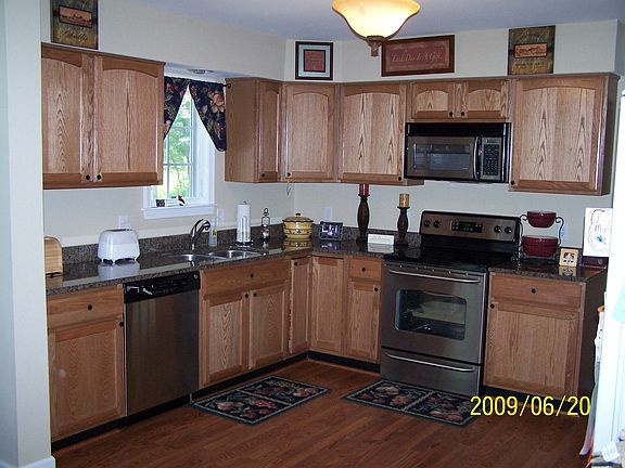 Kitchen with granite countertops and cabinets with pull out shelving